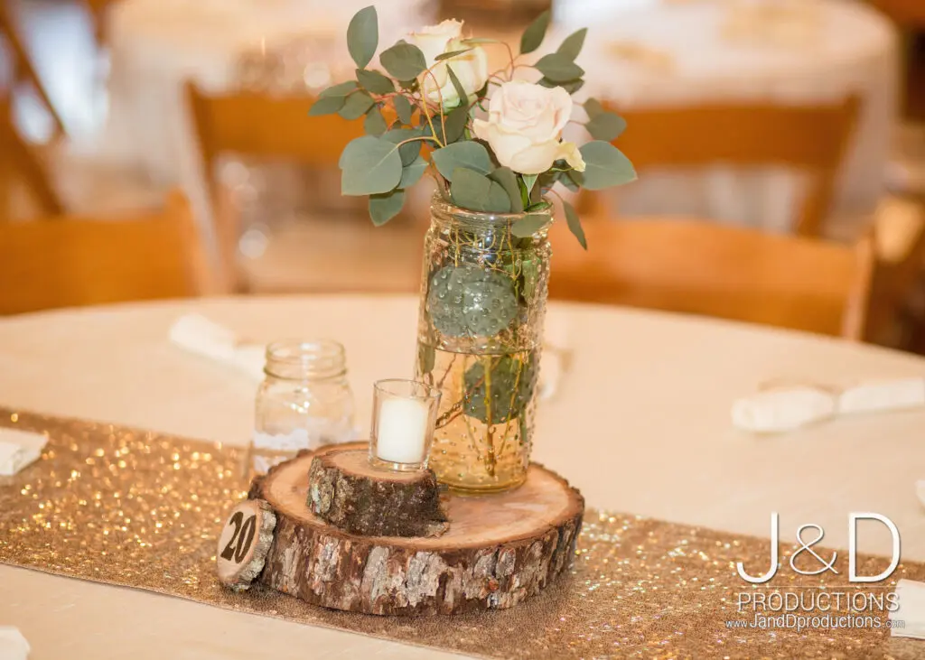 candle and white roses as table centerpieces